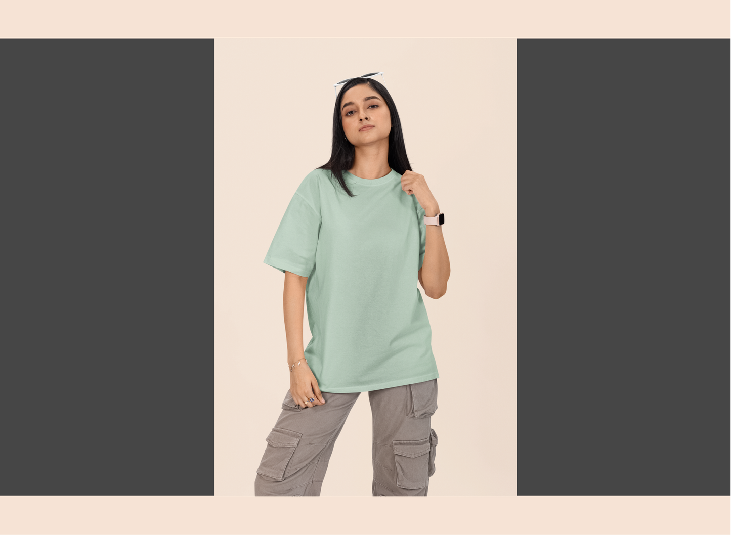Person wearing a light green t-shirt and gray cargo pants on a beige background