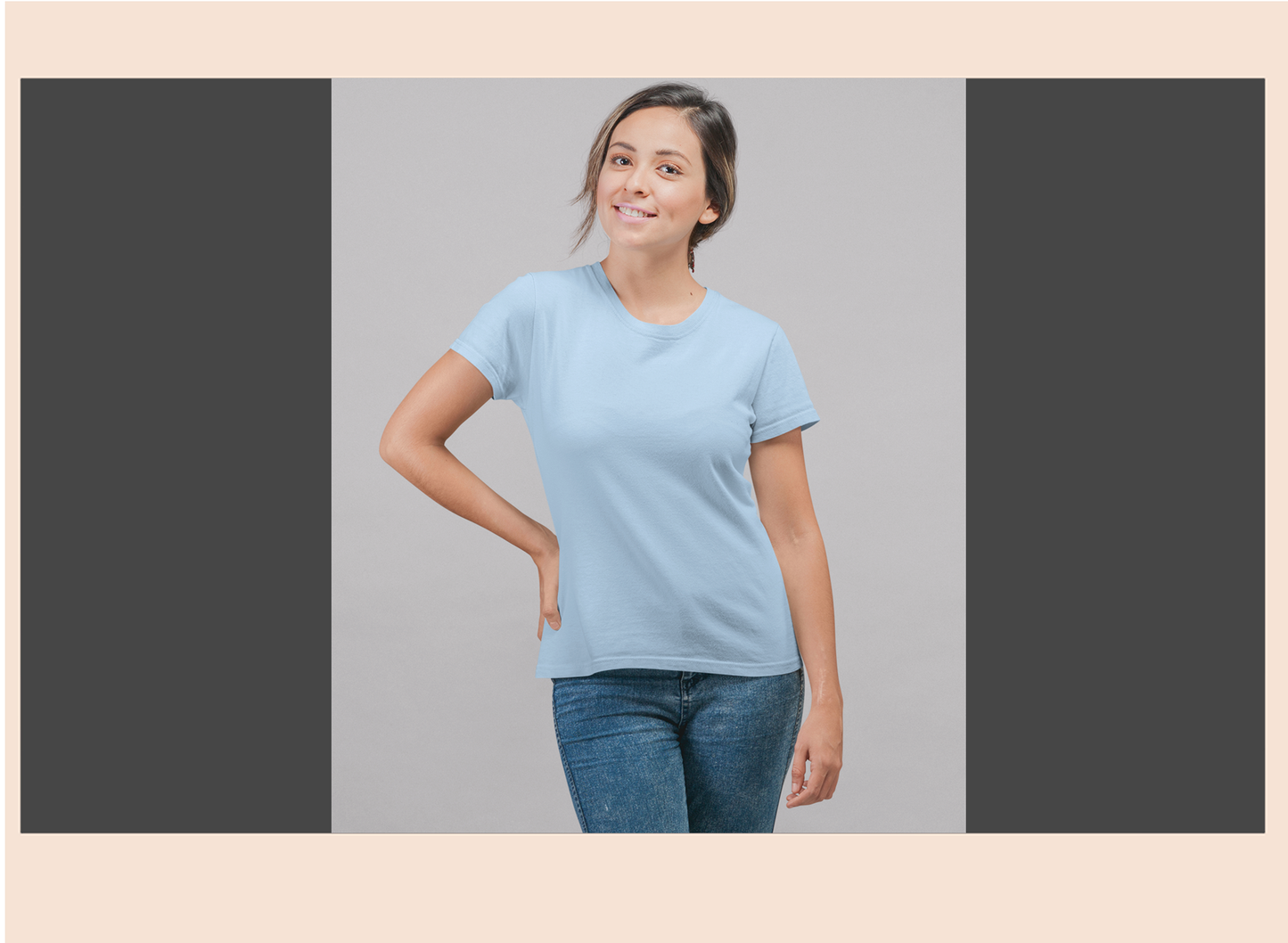 Woman wearing a light blue t-shirt and jeans on a gray background