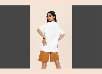 Woman wearing a white t-shirt and brown shorts on a beige background
