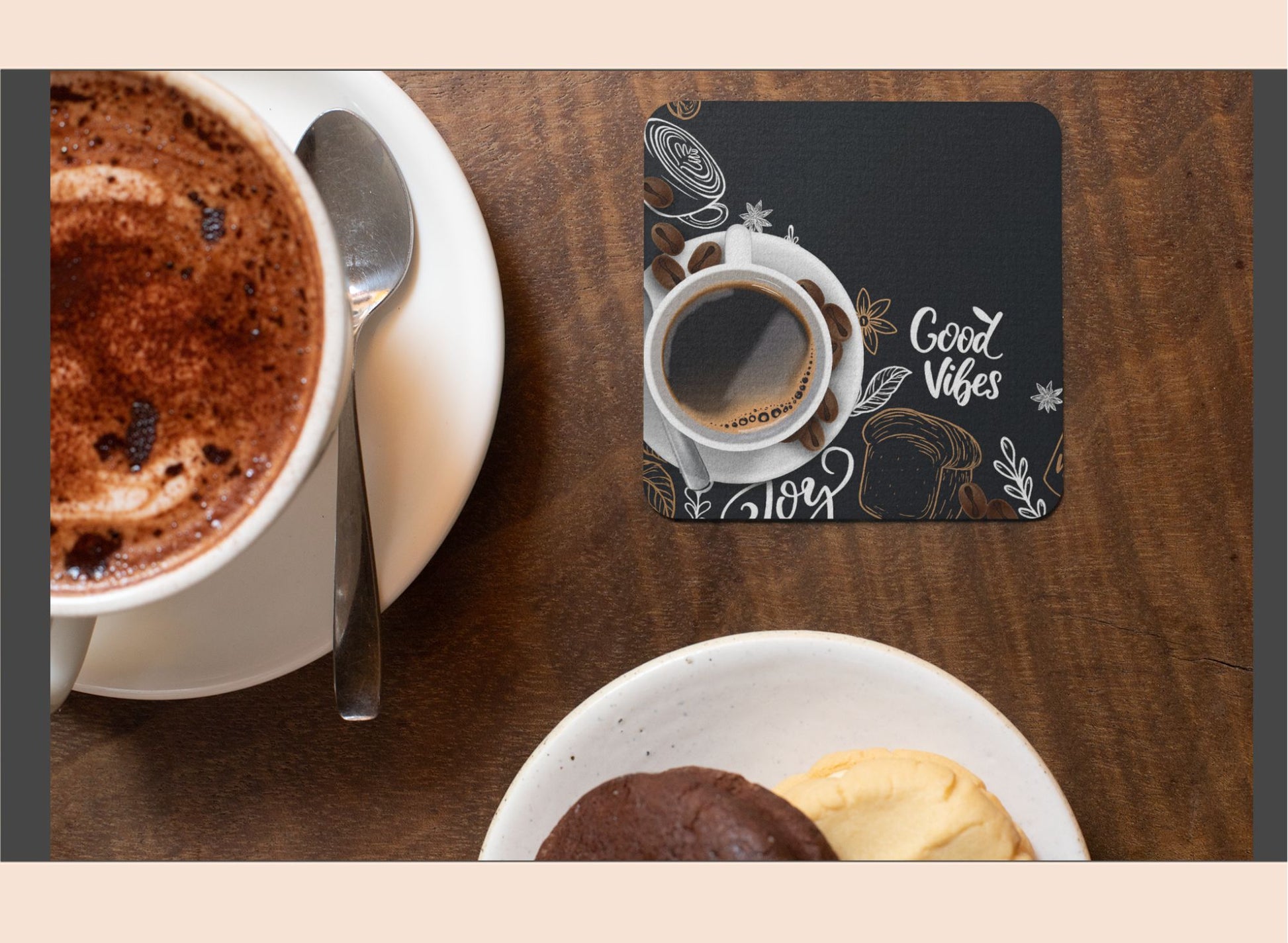 Cup of coffee with a spoon and dessert on a wooden table, coaster with 'Good Vibes' text.