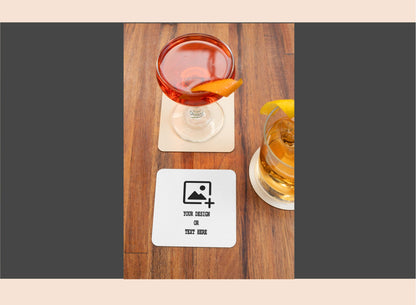 Two cocktails on wooden coasters with a customizable coaster design card.