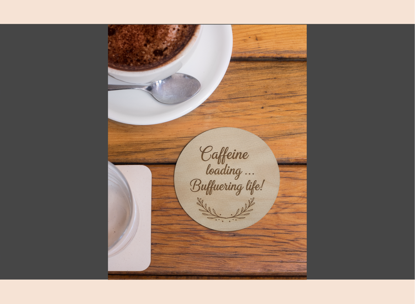 Wooden coaster with humorous text on a wooden table with a cup of coffee.