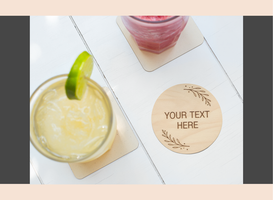 Coaster with drink and lime garnish on a white surface