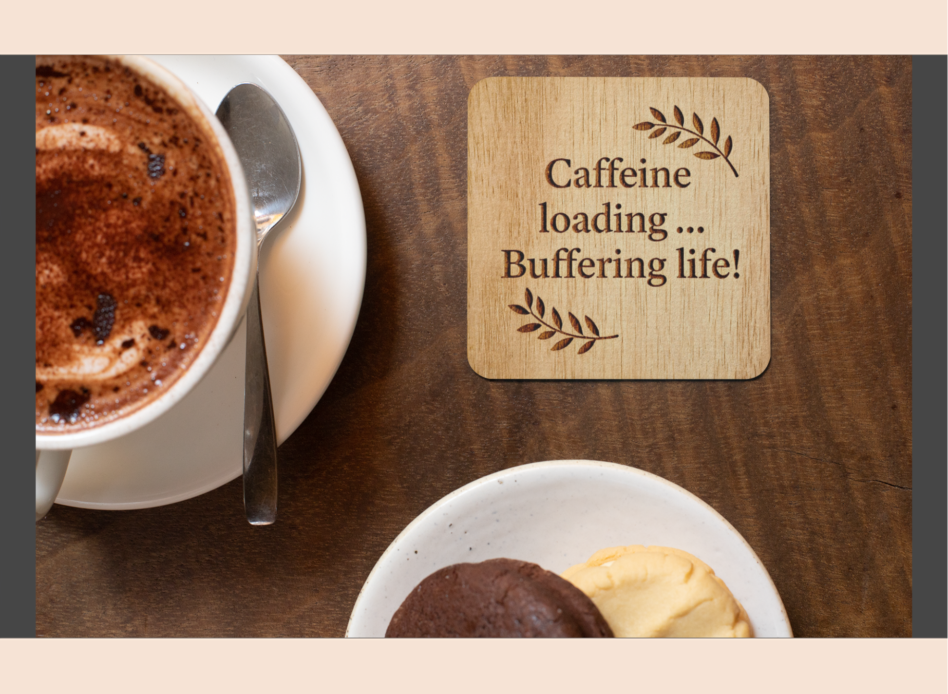 Cup of coffee with a wooden coaster reading 'Caffeine loading... Buffering life!' on a wooden table.