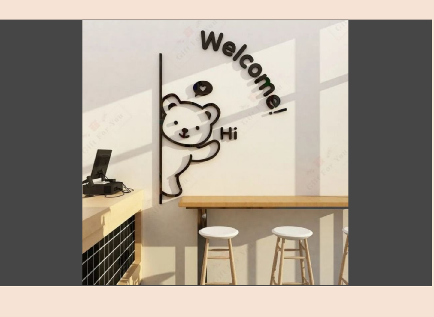 Wall with a cartoon bear design and 'Welcome! Hi' text in a modern interior setting.