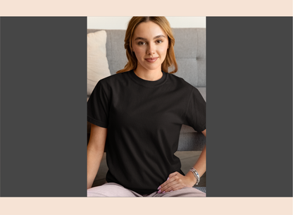 Woman wearing a black t-shirt sitting on a couch with a neutral background