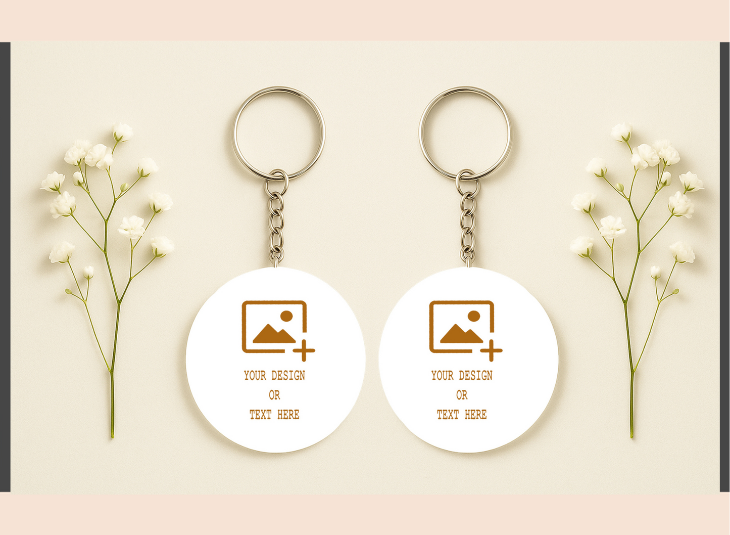 Two white keychains with customizable design or text on a light pink background with baby's breath flowers.