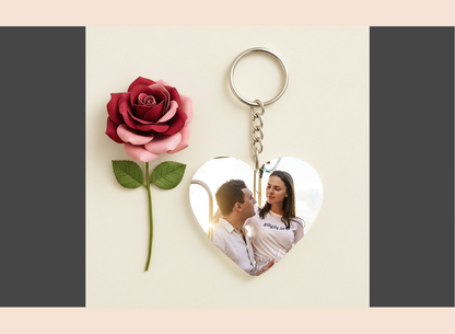 Heart-shaped keychain with a photo of a couple and a red rose on a light background