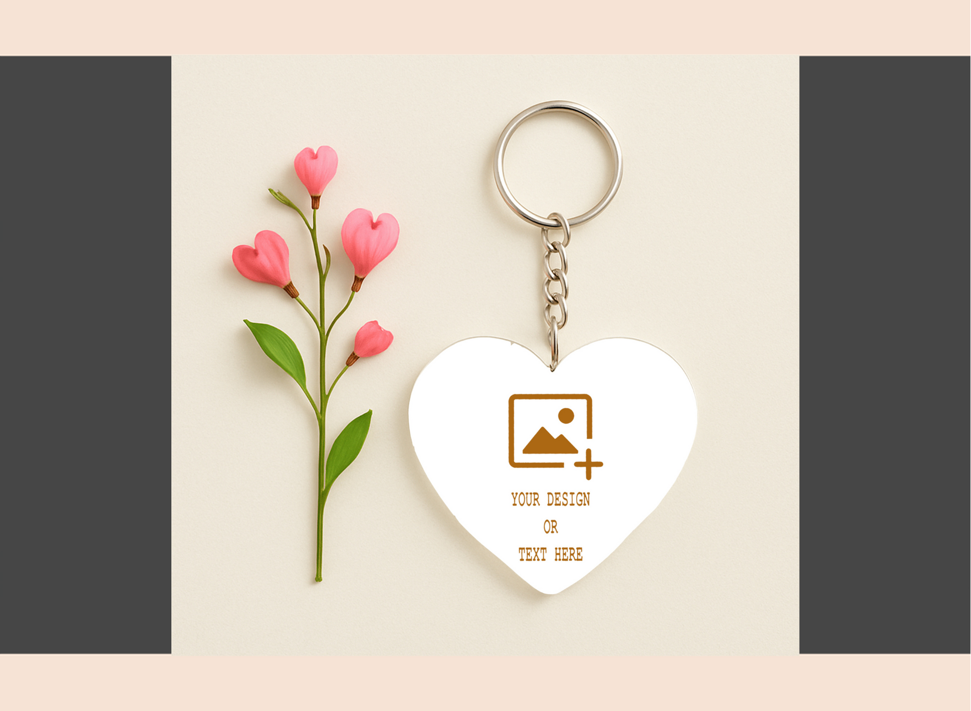 Heart-shaped keychain with customizable design area next to pink flowers on a beige background