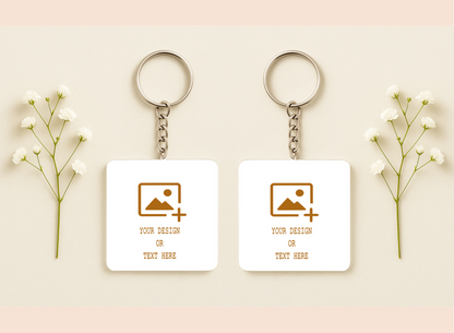 Two customizable keychains with placeholder designs on a light background with baby's breath flowers.