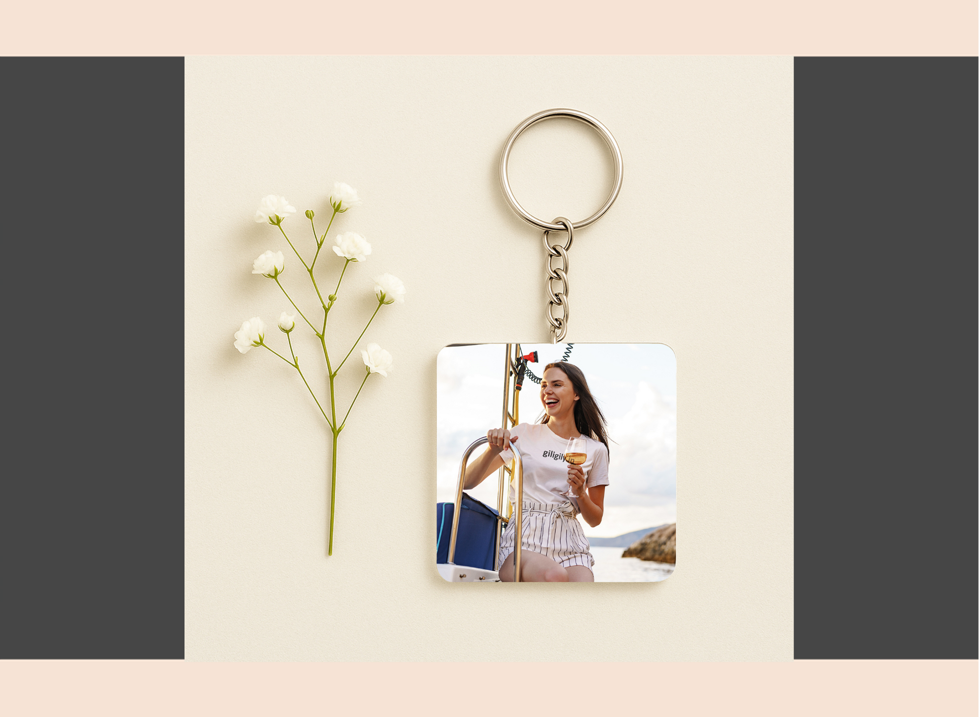 Keychain with a printed photo of a woman holding a glass of wine, placed on a light surface with a flower.