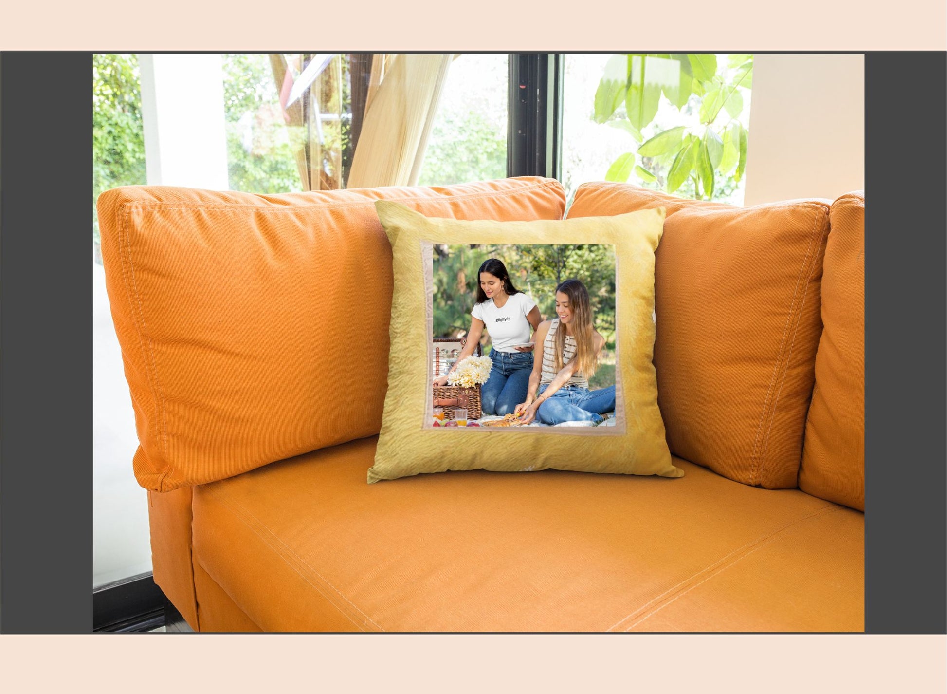 Orange sofa with a pillow featuring two women on a sunny day.