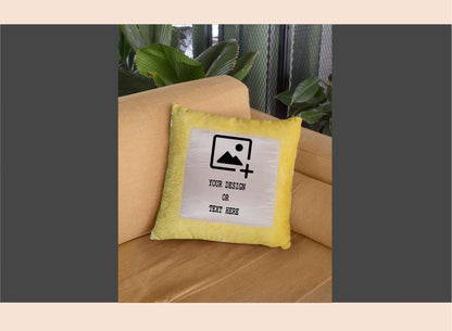 Yellow pillow with customizable design area on a beige couch.